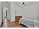 This comfortable bedroom features modern lighting, a dresser for storage, and sleek hardwood floors at 818 Calluna St, Las Vegas, NV 89138