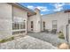 Modern home front entry with stone accents, desert landscaping, and outdoor seating at 818 Calluna St, Las Vegas, NV 89138