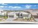 Modern home with desert landscaping, grey pavers, and mountain views at 818 Calluna St, Las Vegas, NV 89138