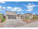 Modern home, grey pavers, desert landscaping, and mountain views at 818 Calluna St, Las Vegas, NV 89138