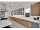 Bright kitchen with white countertop, wooden cabinets, stainless steel appliances, and a modern range hood at 818 Calluna St, Las Vegas, NV 89138