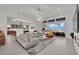 Open-concept living area with tile floors, modern furniture and expansive windows at 818 Calluna St, Las Vegas, NV 89138
