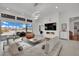 Bright living room with modern chandelier, fireplace, and sliding glass doors at 818 Calluna St, Las Vegas, NV 89138