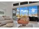 Cozy chair offers view of an outdoor living area through large glass doors at 818 Calluna St, Las Vegas, NV 89138