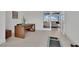Modern office space featuring a sleek wooden desk, plant, and bright, open doorway at 818 Calluna St, Las Vegas, NV 89138