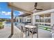 Inviting covered patio with ceiling fan, outdoor dining set, and a view of the pool at 818 Calluna St, Las Vegas, NV 89138