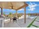 This outdoor kitchen with BBQ grill overlooks a covered patio and refreshing pool area at 818 Calluna St, Las Vegas, NV 89138