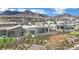 Back of a modern home with a private pool surrounded by desert landscaping and mountain views at 818 Calluna St, Las Vegas, NV 89138