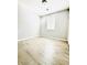 Minimalist bedroom with light wood flooring and neutral gray walls at 8628 Vondel Park St, Las Vegas, NV 89148