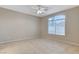 Inviting bedroom with tile floors, ceiling fan, and large window at 1004 Country Skies Ave, Las Vegas, NV 89123