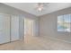 Bedroom showcasing tile flooring, a ceiling fan, window, and closet at 1004 Country Skies Ave, Las Vegas, NV 89123