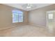 Comfortable bedroom with tile floors, ceiling fan, and plenty of natural light at 1004 Country Skies Ave, Las Vegas, NV 89123