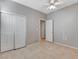 Bright bedroom features tile flooring, a ceiling fan, and a closet at 1004 Country Skies Ave, Las Vegas, NV 89123