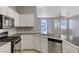 Open concept kitchen with stainless steel appliances, ample counter space, and natural light at 1004 Country Skies Ave, Las Vegas, NV 89123