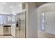 Modern kitchen featuring stainless steel appliances, white cabinets, and an open view of the living area at 1004 Country Skies Ave, Las Vegas, NV 89123