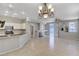 Inviting living room with tile flooring, fireplace, kitchen access, and sliding glass doors at 1004 Country Skies Ave, Las Vegas, NV 89123