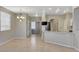 Charming living area with tile flooring, chandelier, and open layout to the kitchen at 1004 Country Skies Ave, Las Vegas, NV 89123