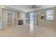 Bright living space with tile floors, fireplace, and sliding door access to the backyard at 1004 Country Skies Ave, Las Vegas, NV 89123