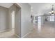 Bright living space with tile floors, seamless flow to the kitchen, and arched doorways at 1004 Country Skies Ave, Las Vegas, NV 89123