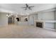 Spacious living room featuring tile floors, a cozy fireplace, and open access to the kitchen at 1004 Country Skies Ave, Las Vegas, NV 89123