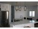 Bright kitchen with a stainless steel refrigerator and an expansive quartz countertop island at 1066 Slate Crossing Ln # 3, Henderson, NV 89002