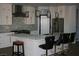 Stylish kitchen with white cabinetry, a large island, and modern pendant lighting at 1066 Slate Crossing Ln # 3, Henderson, NV 89002