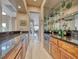 Home bar with wine cooler, glassware display, and granite countertops at 11593 Glowing Sunset Ln, Las Vegas, NV 89135