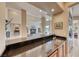 Wet bar featuring granite countertops and views into the Gathering room at 11593 Glowing Sunset Ln, Las Vegas, NV 89135