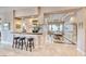 Home wet bar featuring seating, granite countertops, and a beautiful view at 11593 Glowing Sunset Ln, Las Vegas, NV 89135