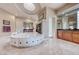 Spacious bathroom featuring a large jacuzzi tub, dual vanities, and a walk-in shower at 11593 Glowing Sunset Ln, Las Vegas, NV 89135