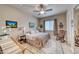 Comfortable bedroom with a ceiling fan, window with blinds, and a vintage rocking chair at 11593 Glowing Sunset Ln, Las Vegas, NV 89135
