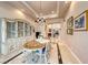 Elegant dining room featuring a decorative hutch, chandelier, and marble floors at 11593 Glowing Sunset Ln, Las Vegas, NV 89135