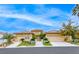 Beautiful single-story stucco home with a three-car garage, tile roof and well-manicured front yard at 11593 Glowing Sunset Ln, Las Vegas, NV 89135