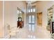Grand foyer featuring marble floors, a crystal chandelier, and a view of the double-door entry at 11593 Glowing Sunset Ln, Las Vegas, NV 89135