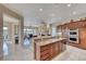 Spacious kitchen with a granite center island and stainless steel appliances, offering seamless flow at 11593 Glowing Sunset Ln, Las Vegas, NV 89135