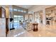 Bright living room featuring large windows, high ceilings, marble floors, and comfortable seating at 11593 Glowing Sunset Ln, Las Vegas, NV 89135