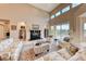 Bright living room featuring high ceilings, fireplace, and access to outdoor patio at 11593 Glowing Sunset Ln, Las Vegas, NV 89135