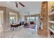 Spacious living room with stone fireplace and large windows with outdoor views at 11593 Glowing Sunset Ln, Las Vegas, NV 89135