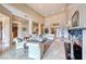 Spacious living room with high ceilings, marble floors, fireplace, and abundant natural light at 11593 Glowing Sunset Ln, Las Vegas, NV 89135