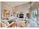 Open living room with high ceilings, tile floors, a fireplace, and comfortable furniture at 11593 Glowing Sunset Ln, Las Vegas, NV 89135