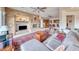 Open-concept living room featuring a stone fireplace, media center, and access to the kitchen at 11593 Glowing Sunset Ln, Las Vegas, NV 89135