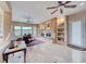 Bright living room with stone fireplace, mantel, and built in shelving at 11593 Glowing Sunset Ln, Las Vegas, NV 89135