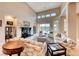 Elegant living room with high ceilings, tile flooring, and a fireplace at 11593 Glowing Sunset Ln, Las Vegas, NV 89135