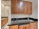 Office area featuring a dark countertop, wood cabinets, and a stainless steel faucet at 11593 Glowing Sunset Ln, Las Vegas, NV 89135