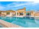Luxurious backyard featuring a large pool and spa, perfect for relaxation and entertainment at 11593 Glowing Sunset Ln, Las Vegas, NV 89135