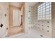 Bright and spacious walk-in shower featuring glass block windows and tiled walls at 11593 Glowing Sunset Ln, Las Vegas, NV 89135