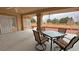 Covered back patio featuring patio furniture and views of a nearby field at 1211 Bourbon St, Pahrump, NV 89048