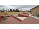 Expansive backyard featuring desert landscaping and a low red brick wall at 1211 Bourbon St, Pahrump, NV 89048