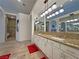 Bright bathroom featuring double sinks, granite countertops, and shower at 1211 Bourbon St, Pahrump, NV 89048