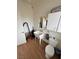 Garage half-bath with utilitarian sink and tiled floor at 1211 Bourbon St, Pahrump, NV 89048